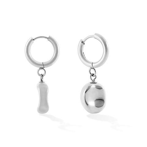 Dawn women's pendant earring by Five Jwlry, born from Alicia Moffet's collaboration. This design marries a timeless hoop with a pendant resembling a water droplet, creating an illusion of molten metal frozen in time. Available in 14k gold or silver, made from water-resistant 316L stainless steel. Hypoallergenic with a 2-year warranty.